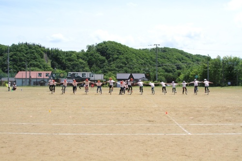 Students ride unicycles in Kamiokoppe Sports Festival.